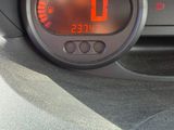 a digital clock on the dashboard of a car