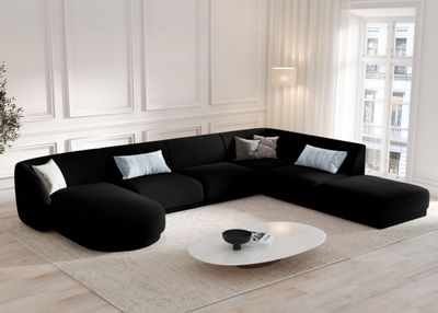 a large black couch in the middle of a living room