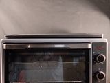 a toaster oven sitting on top of a wooden table