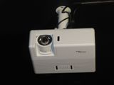a camera attached to a wall mounted projector