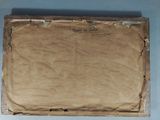 two pieces of brown paper sitting on top of a table next to each other