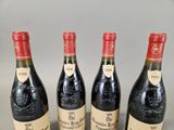 three bottles of red wine are lined up on a table