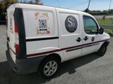 a white van parked in a parking lot with a sticker on the side of the van
