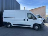 a picture of a white van parked in front of a building