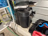 a black trash can with a tennis racket and a tennis racquet