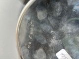 a close up of a silver vase with a label on it