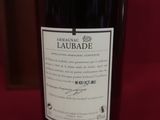 a close up of a bottle of liquor on a red surface