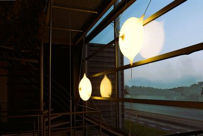 three lights that are hanging from the ceiling of a building