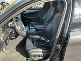 the interior of a car with the door open and the driver ' s seat up