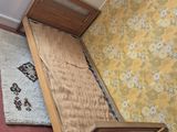 an overhead view of a bedroom with a bed, dresser, and rug