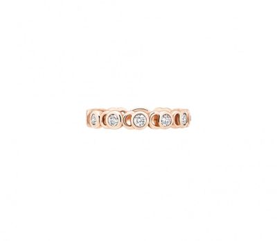 a rose gold ring with three diamonds