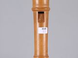 a wooden pepper mill on a table with a label on it