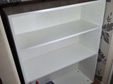 a white shelf with a blue blow dryer on top of it