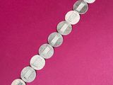 a close up of a bracelet made out of coins on a pink background