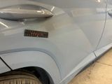 a close up of a car door handle with a sticker on it