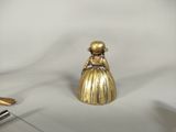 a gold figurine sitting on a table next to a pair of scissors