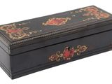 an image of a black wooden box with red flowers on it