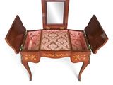 a small wooden table with a mirror on top of it