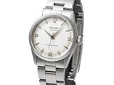 the watch is silver and white with roman numerals on the dial