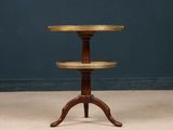 a tall wooden table with three tiered trays on it