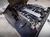 an old car with a engine in the back of it