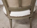 a chair that has a cushion on it in a room