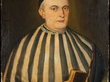 portrait of a man in a striped robe holding a book