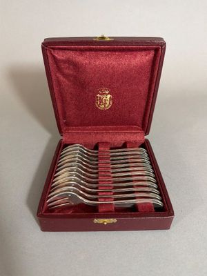 a red box with silverware in it on a table