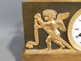 a gold clock with a statue of an angel on top of it