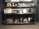 a metal shelf with pots and pans on top of it