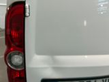 a white van parked in a parking lot next to a building