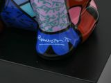 a colorful elephant statue on display on a black surface