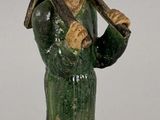 figurine représentant un homme tenant une batte de baseball sur une base