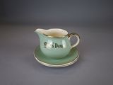 a small cup and saucer sitting on a saucer