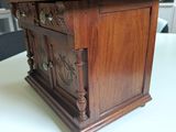 a small wooden cabinet on a table in a room