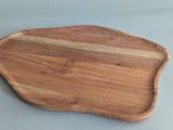 a close up of a wooden cutting board on a table