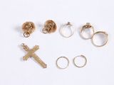 several rings, a cross, a ring, a ring, and a cross are arranged on a white surface