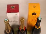 two bottles of champagne and a box of wine on a table