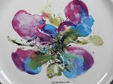 a plate with a painting of a flower on it