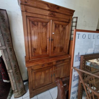 a wooden cabinet with a mirror on top of it