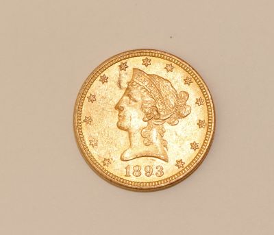 an image of a gold coin with a woman ' s head on it