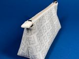 a white purse sitting on top of a blue surface