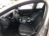 the interior of a car with the door open and the driver ' s seat down