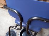 a blue wheelbarrow with a black handle and a blue seat