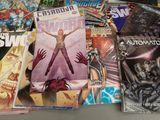 a lot of comic books on the table together