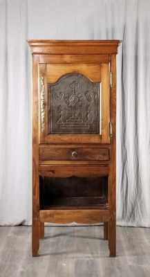 an old wooden cabinet with a door and a drawer on top of it