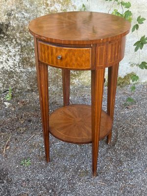 a small wooden table with a drawer on top of it