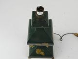a green lamp that is on top of a table