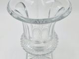 a clear glass vase with spoons inside of it