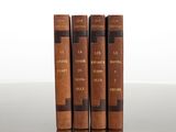 three old books sitting on top of a table next to each other